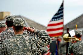 Soldiers saluting the Flag