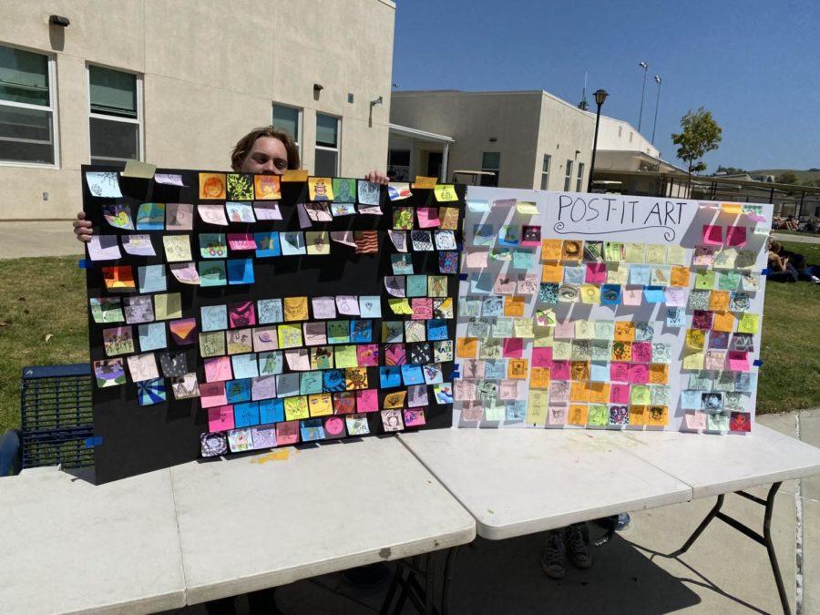 Pictured Virgil Andreasen holding board of AGHS Student Post-it Note art submissions 
Photo courtesy of Virgil Andreasen