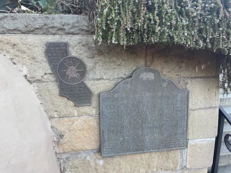 Small plaques surrounding the historical site indicate brief summaries of the mission history, leaving out the more brutal aspects