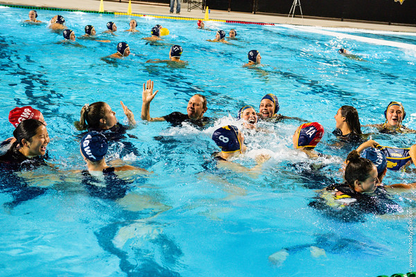 Coach Allen celebrates with his players after being tossed in the pool following the 20th league win