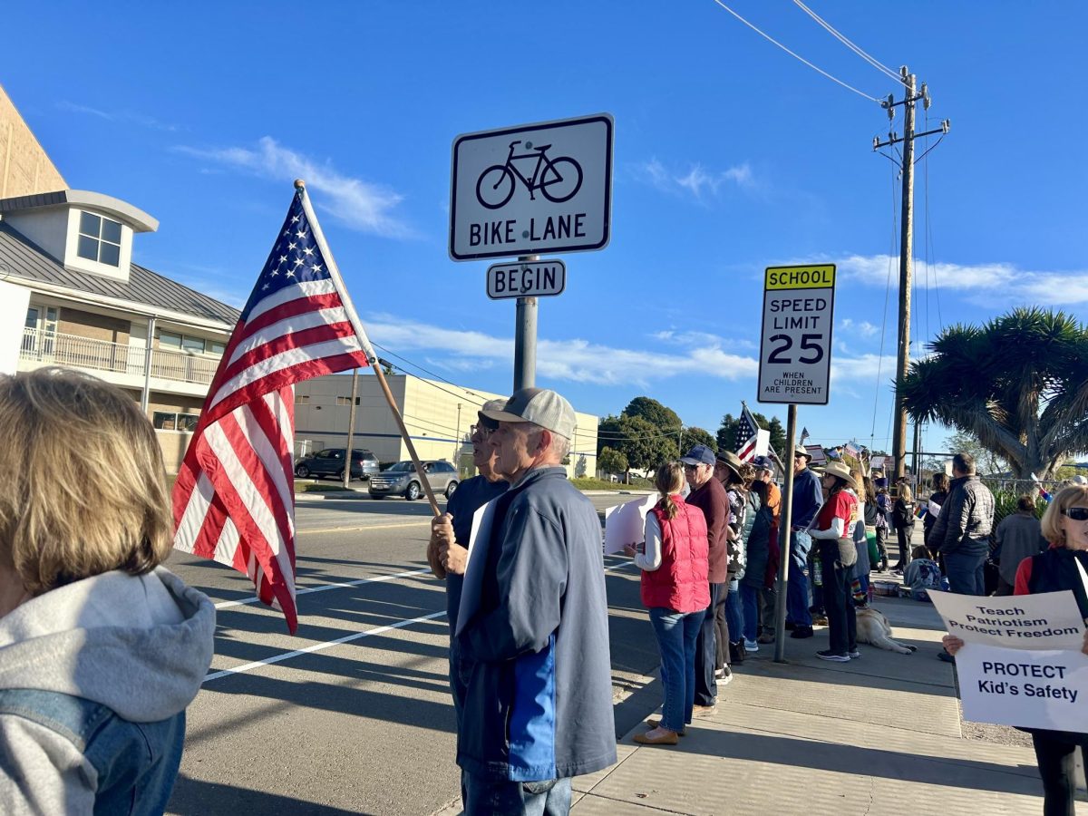 First Amendment rights protesters stand on the intersection of Fair Oaks and Valley Road to advocate against unjust laws.