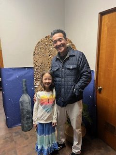 Aaron Sue shows up to the event with his youngest daughter