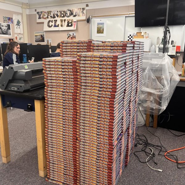 Stacks of yearbooks are waiting to be picked up in room 801!