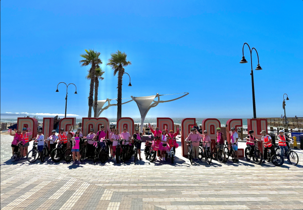 All 25 electric bike riders wore pink to raise awareness for breast cancer. 
