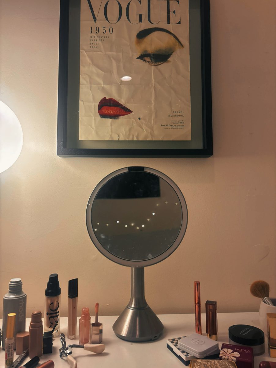 A variety of makeup products displayed on a vanity, emphasizing popular makeup trends among students.

