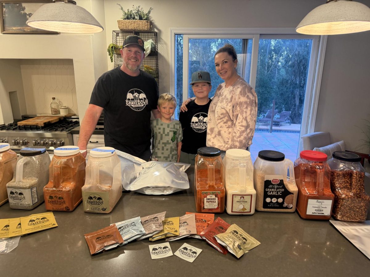 Patrick Cleary, a AGHS alumni, next to his family showcasing Shakedown Seasoning. 