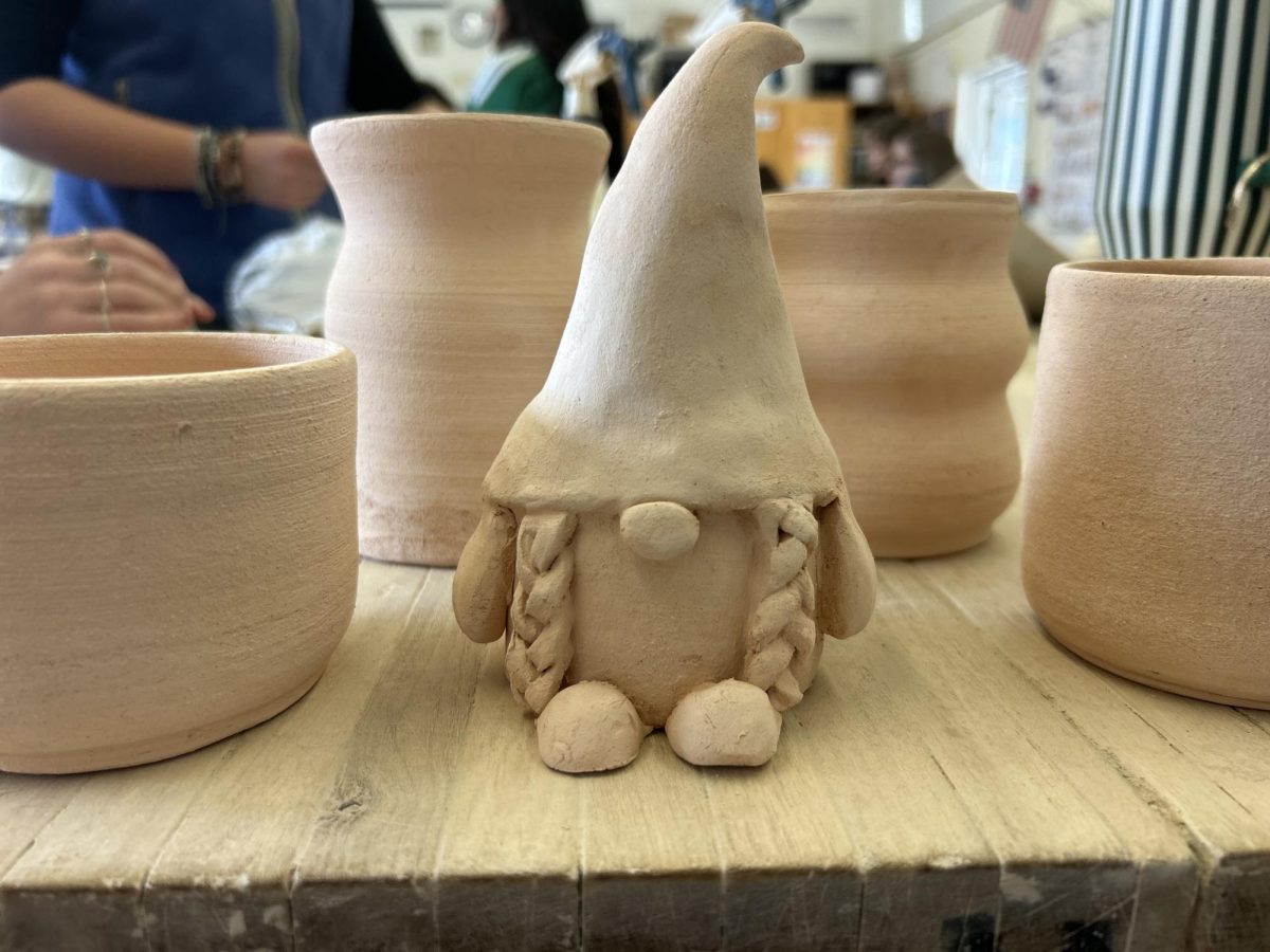Eleni Come's ('26) Garden gnome project, as well as four of her mugs. 