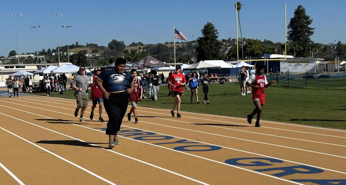 Close race in heat 3 of the 100 meter dash with Aylis Figeuroa-Council('27) of Arroyo Grande High School in the lead.