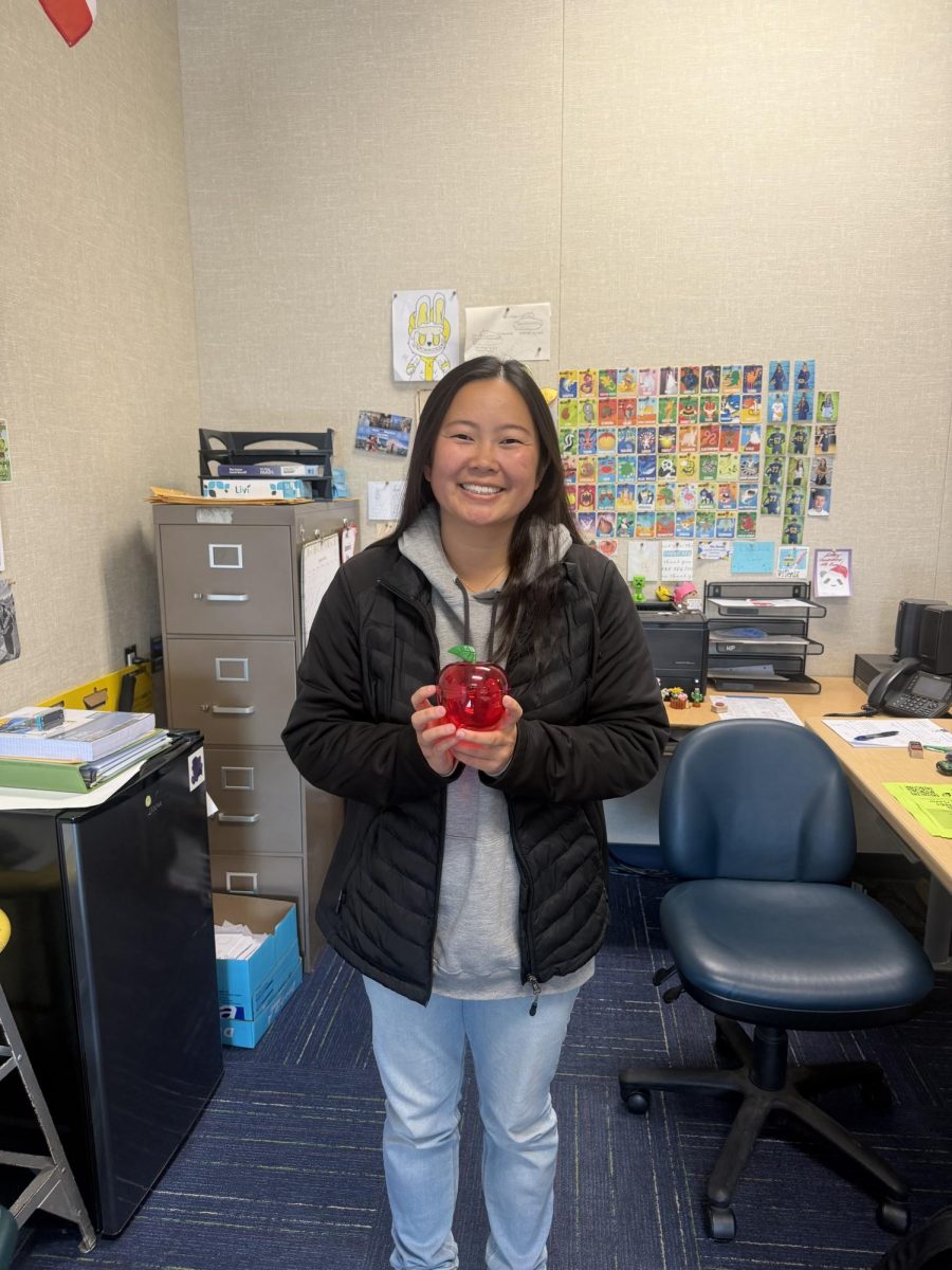 Victoria Donis in room 970 showing off her classroom staple, the apple. 
