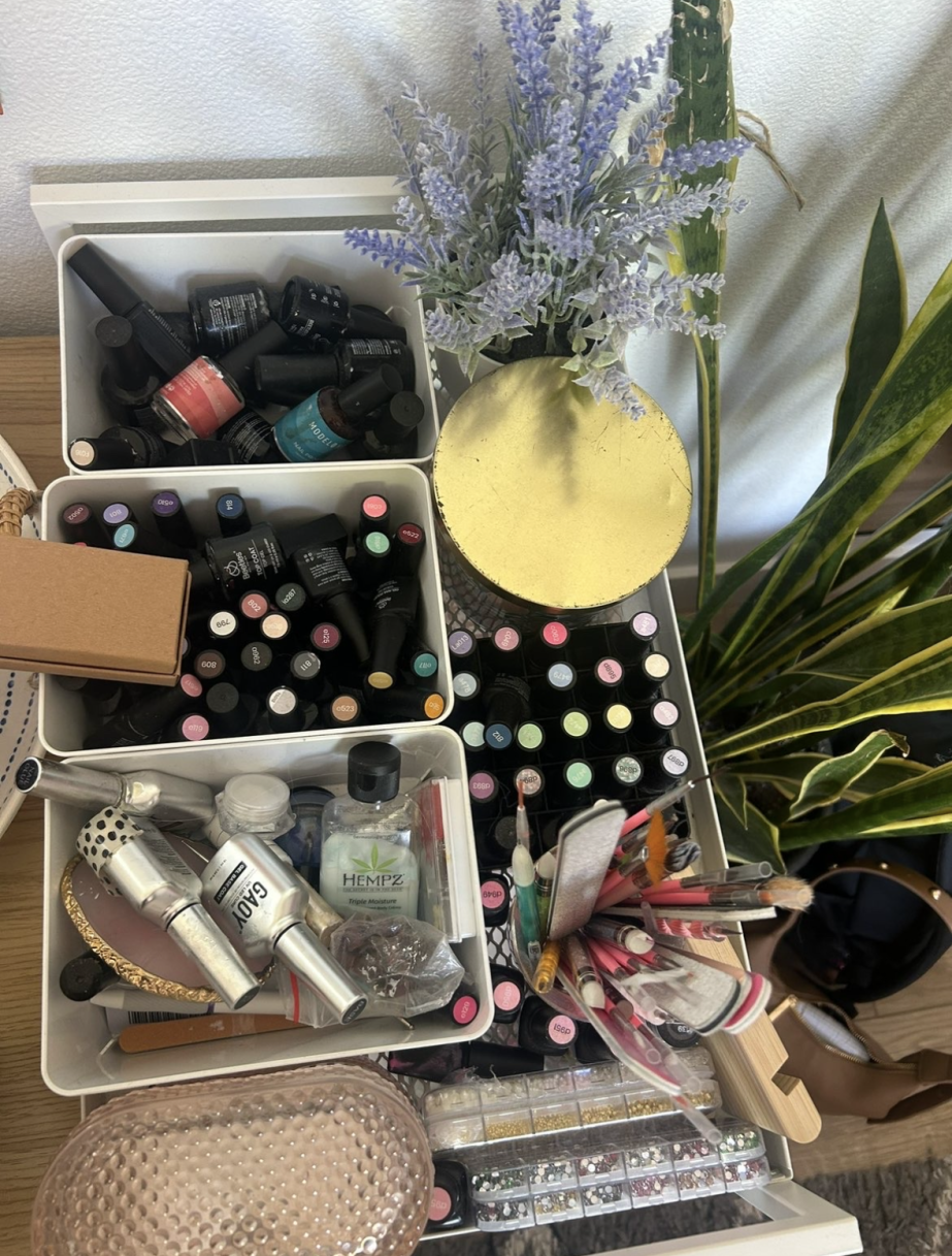 Gibson has a dedicated space on her desk filled with a variety of nail polishes, tools, and gems.
